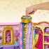 Toy wardrobe with gold and pink accents, featuring a hand interacting with it.