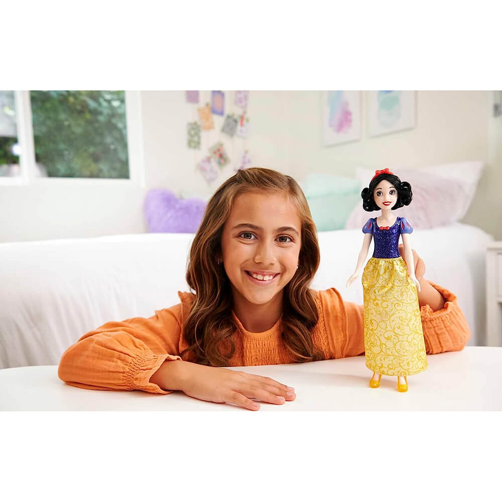 Girl playing with Disney Princess Snow White Fashion Doll