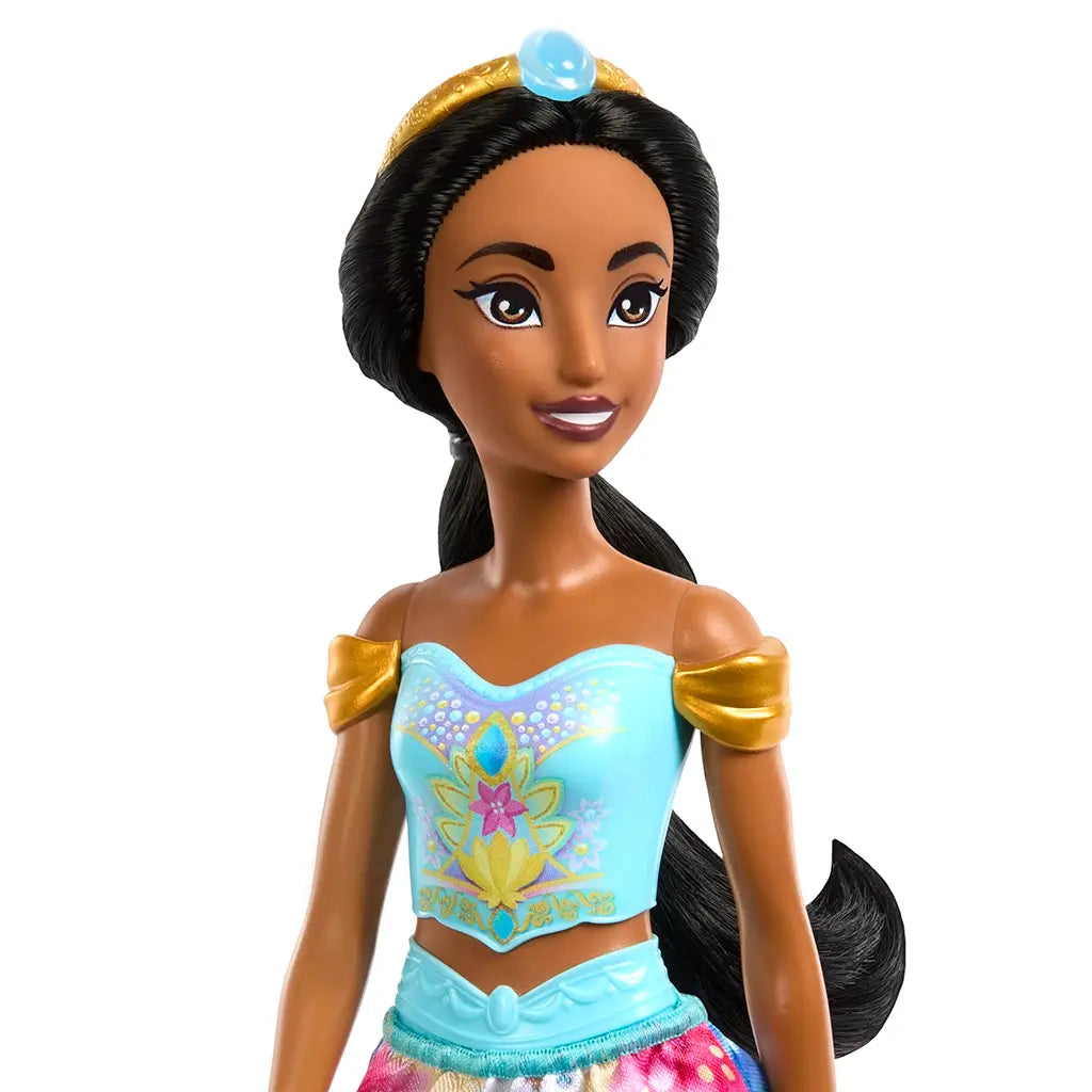 Close-up of Disney Princess Jasmine fashion doll with black hair, blue and gold tiara, off-the-shoulder top, and colorful details.