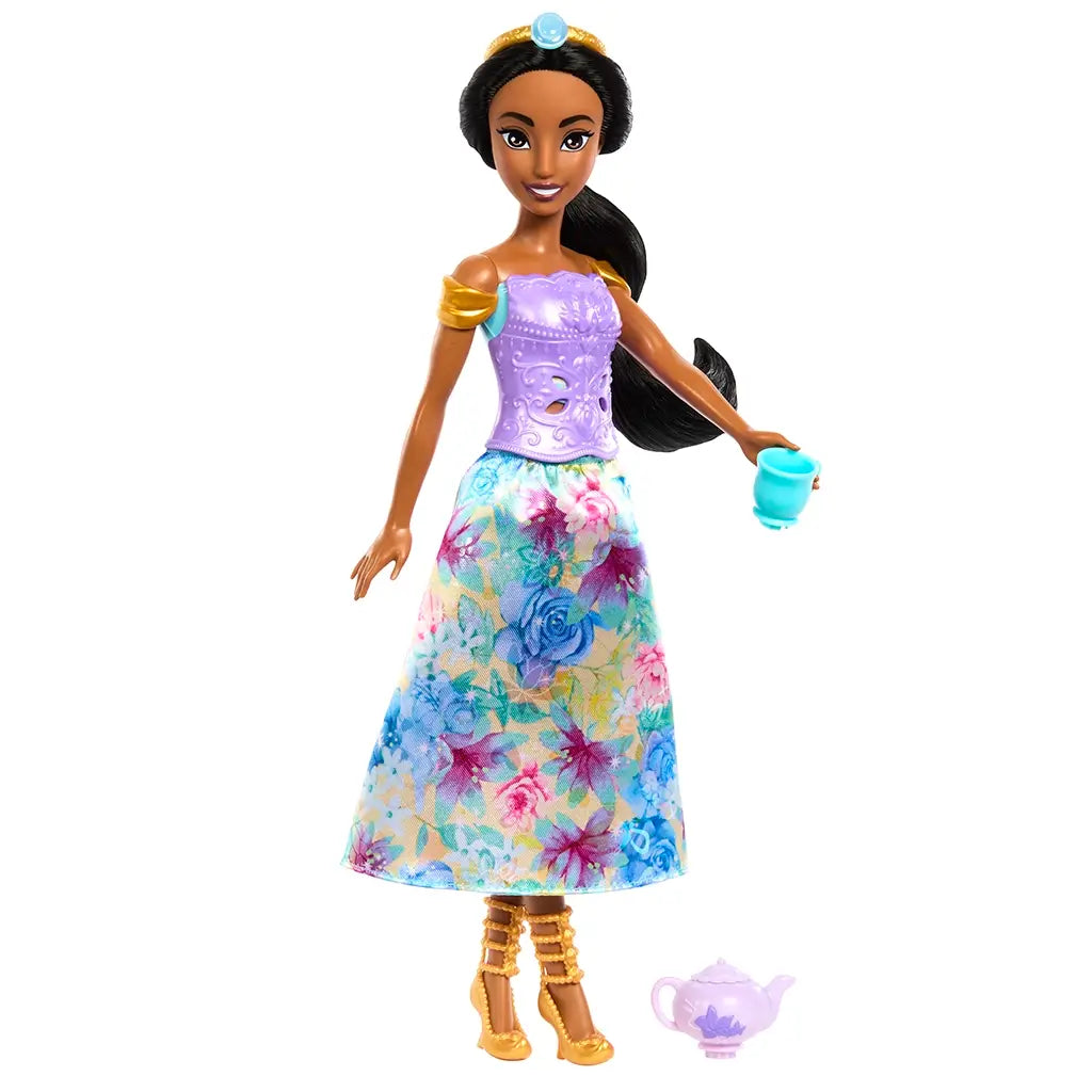 Disney Princess Jasmine fashion doll wearing floral skirt, purple bodice, golden shoes, and accessories, posed with teapot and cup.
