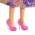 Close-up of Rapunzel doll’s feet wearing translucent pink high-heeled shoes with textured floral design, shown under a detailed purple and gold floral dress.