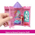 Disney Princess Tower Surprise playset being opened by hand to reveal Ariel figure inside, displaying purple and teal castle interior and text reading “Open to Reveal Surprise Doll!” on bottom banner.