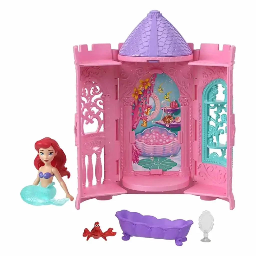 Open Disney Princess Tower Surprise playset with Ariel figure, purple bathtub, Sebastian crab, and mirror accessory inside a detailed pink castle decorated with aquatic-themed designs and windows.