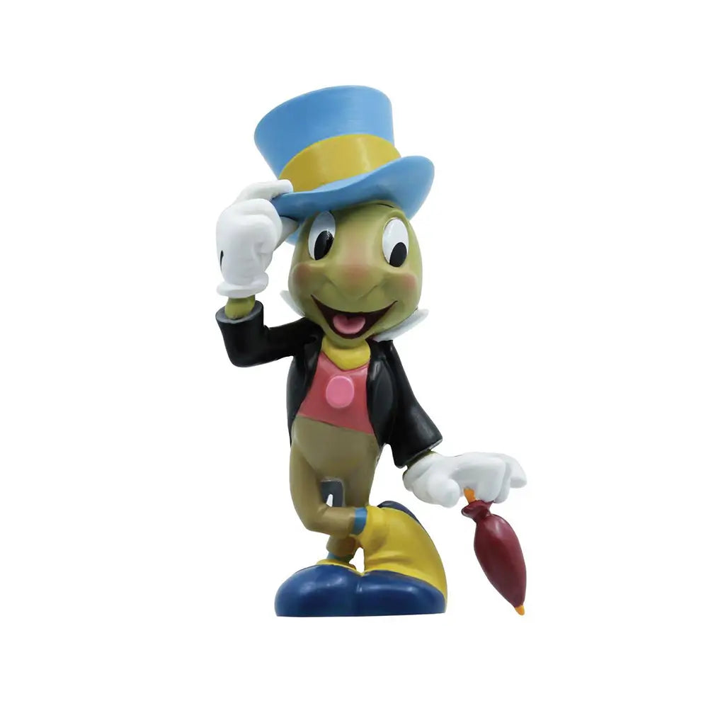 Front view of Jiminy Cricket figure wearing blue hat, black jacket, and red vest, holding umbrella with a smile; Disney Showcase 85th anniversary Pinocchio collectible.