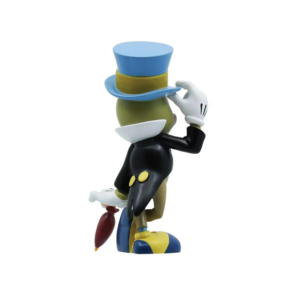 Rear angle of Jiminy Cricket collectible wearing a tuxedo coat with yellow buttons, standing cheerfully with umbrella; Disney Pinocchio 85th anniversary edition.