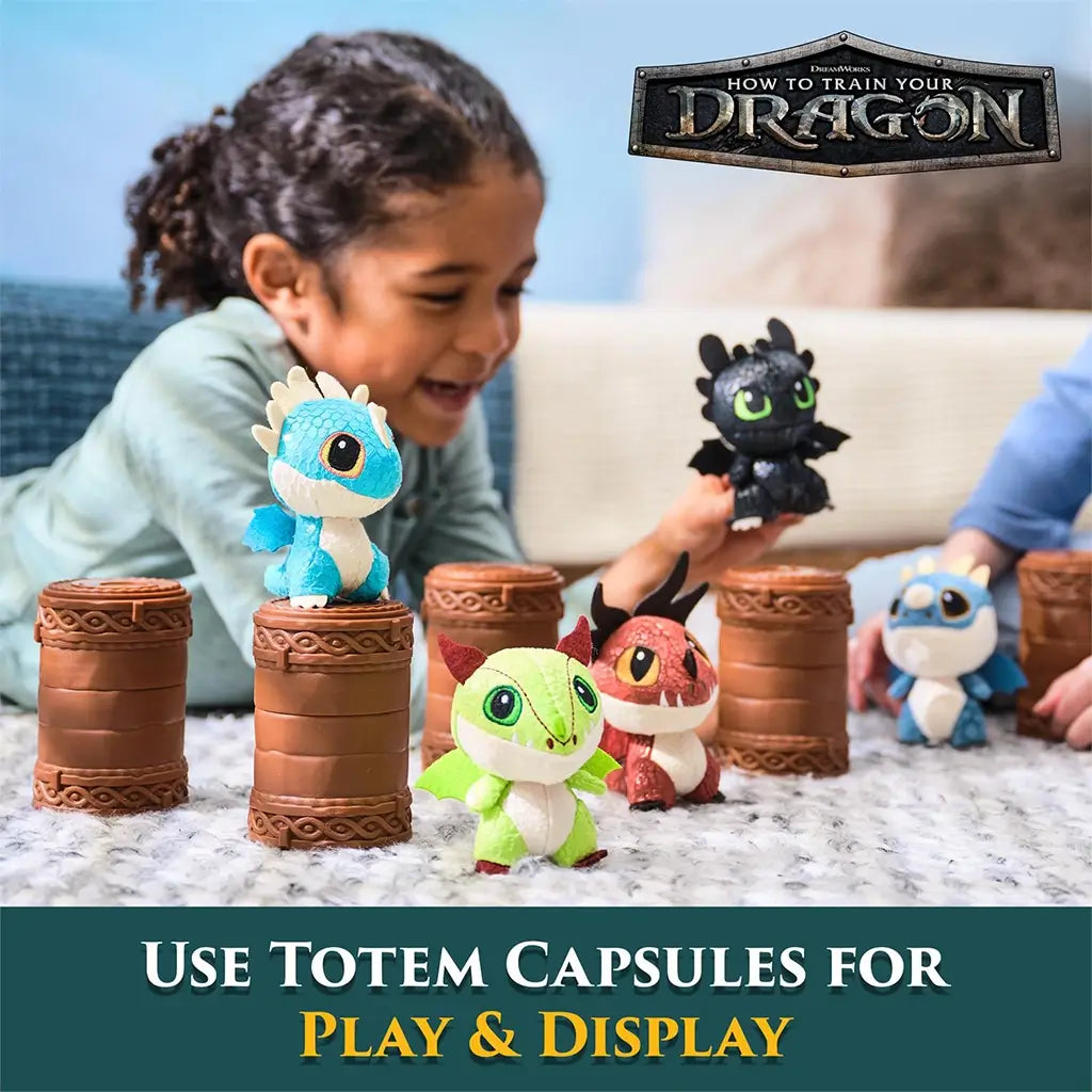 DreamWorks How to Train Your Dragon mini plush figures in blue, green, red, and black textured fabric, posed on brown cylindrical totem capsules for playful display on a carpeted floor.