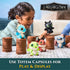 DreamWorks How to Train Your Dragon mini plush figures in blue, green, red, and black textured fabric, posed on brown cylindrical totem capsules for playful display on a carpeted floor.