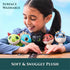 How to Train Your Dragon plush collection in green, blue, black, and red soft textured fabric with embroidered eyes, lined up on a wooden table for surface washable, snuggly play display.
