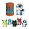 DreamWorks How to Train Your Dragon mini plush set in blue, green, red, and black textured fabric with round shapes and small wings, displayed beside branded brown capsule packaging on white background.