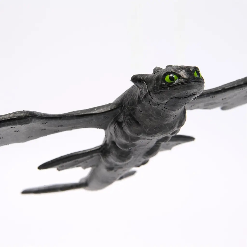 Close-up of the Soaring Toothless glider toy highlighting detailed sculpting, bright green eyes, and textured wings that capture the dragon’s fierce yet friendly appearance.
