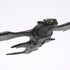 Close-up of the Soaring Toothless glider toy highlighting detailed sculpting, bright green eyes, and textured wings that capture the dragon’s fierce yet friendly appearance.