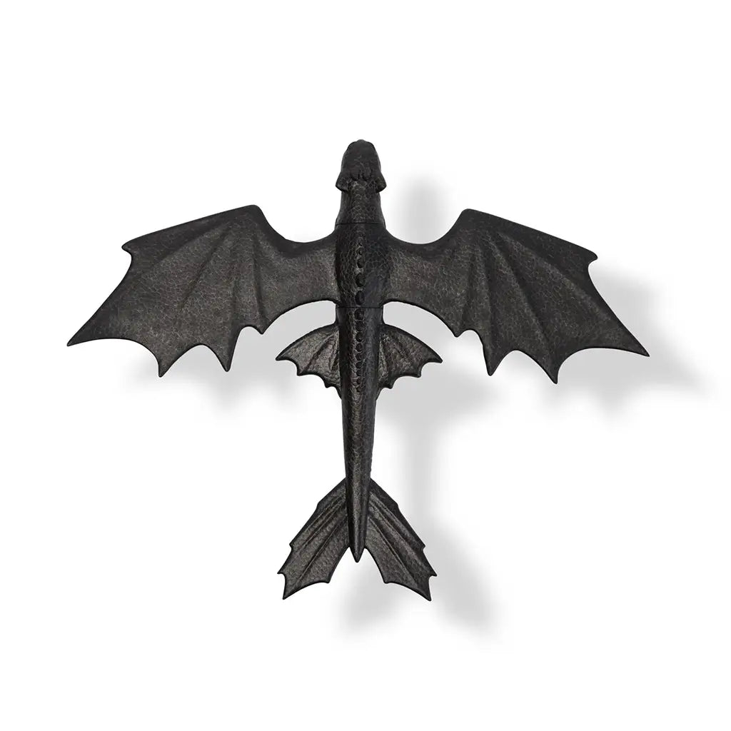 Top view of the DreamWorks Toothless glider toy showing full 15-inch wingspan, wide tail fins, and black textured surface for realistic flying play.