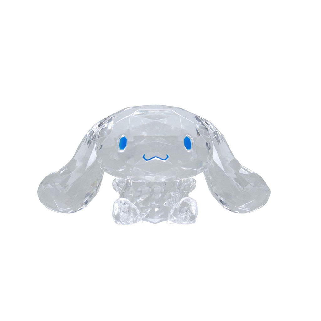 Clear crystal Cinnamoroll figurine with blue eyes and floppy ears, sculpted with faceted surfaces for sparkle; a collectible Sanrio display toy