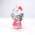 Rear side angle view of Hello Kitty figurine made from clear faceted acrylic, featuring a red bow, pink outfit, and sculpted crystal-like texture.