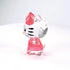 Side view of faceted Hello Kitty figurine in clear crystal-like acrylic, showing signature red bow, whisker details, and pink dress.