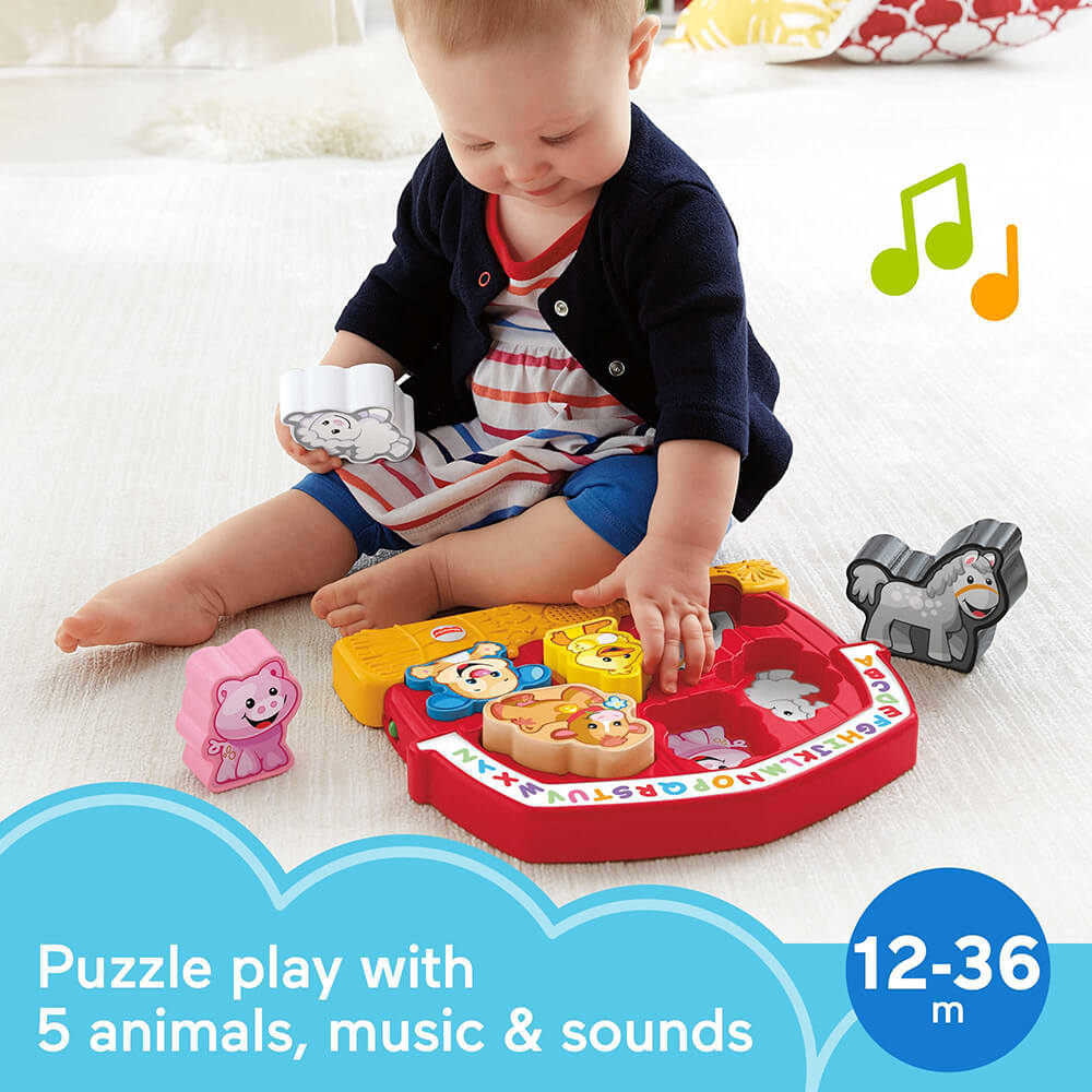 Child playing with the Fisher-Price Laugh & Learn Farm Animal Puzzle. Stating that ages are 12-36 months. It says it is a puzzle play with 5 animals, music and sounds.