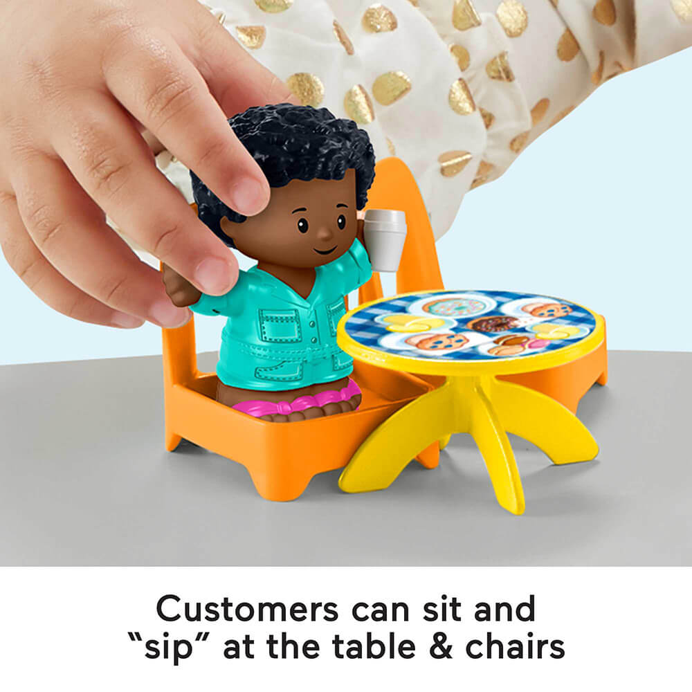 Customers can sit and sip at the table and chairs of the Fisher-Price Little People Lemonade Stand Playset