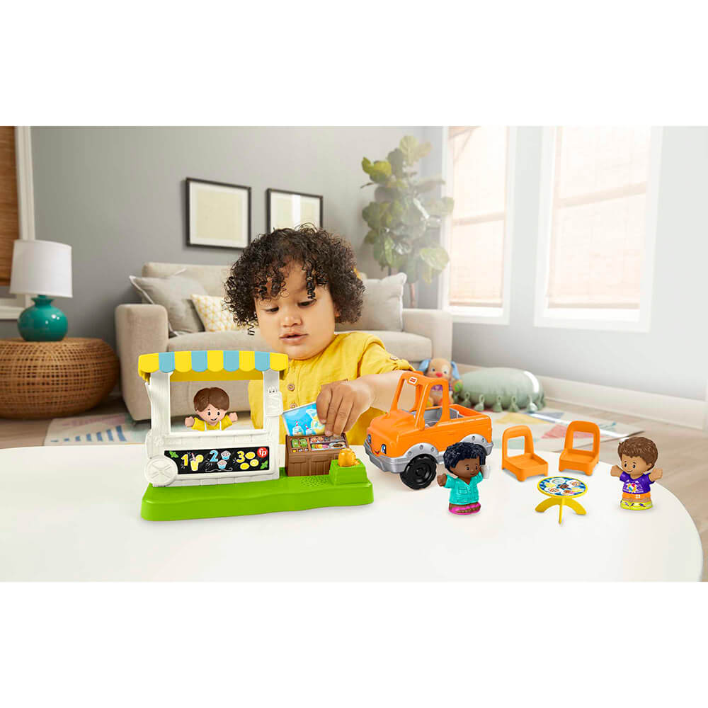 Child playing with the Fisher-Price Little People Lemonade Stand Playset