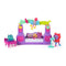 Gabby's Dollhouse The Movie Paw-some Party Story playset in purple and pink plastic with cat-shaped speakers, rainbow music arch, keyboard stage, and mini cat figures arranged on a white background.