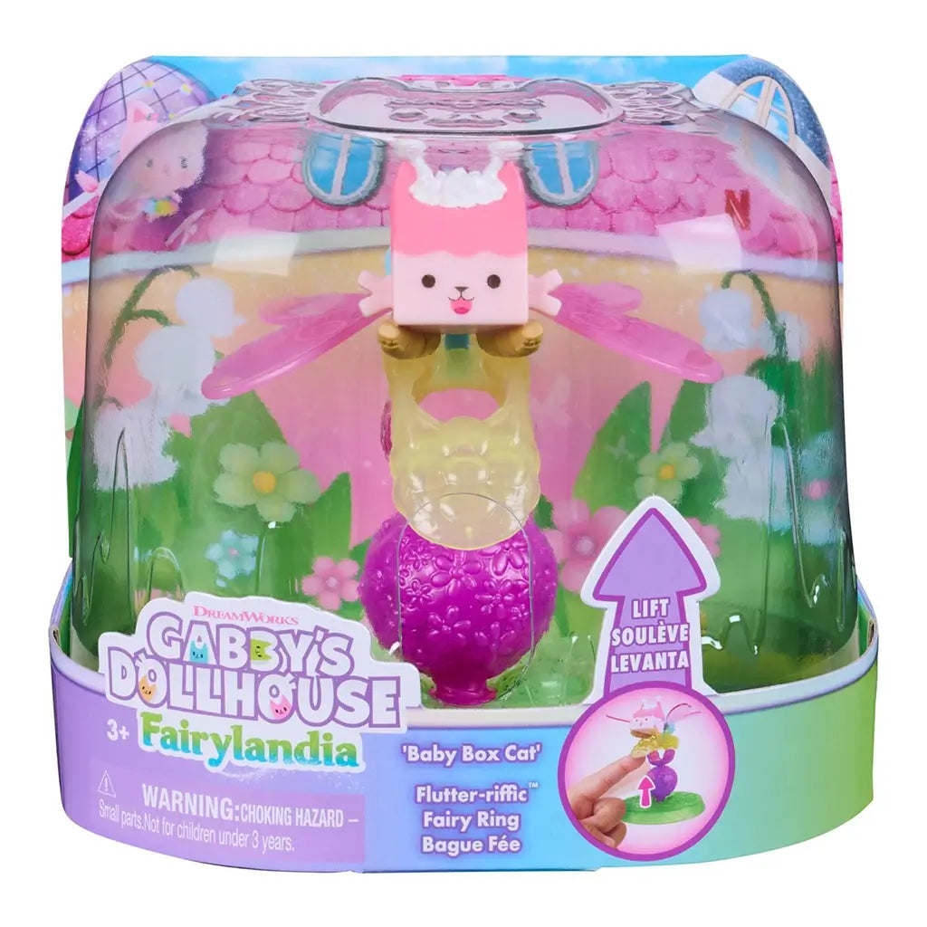 Gabby’s Dollhouse Fairylandia Baby Box Cat toy in pink, yellow, and green plastic with clear dome packaging, featuring winged character and ring base, designed for imaginative play on a white background.