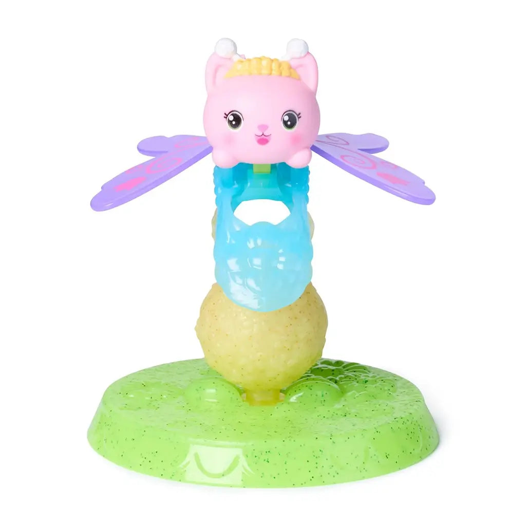 Gabby’s Dollhouse Kitty Fairy figure in pastel pink, purple, and blue glossy plastic with winged shape and textured base stand, designed for imaginative play, displayed on a white background.