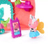 Gabby's Dollhouse fairy mini figures in pink and teal plastic with winged cat character facing a purple mirror inside a coral cat-ear playset, styled as a dress-up vanity scene.