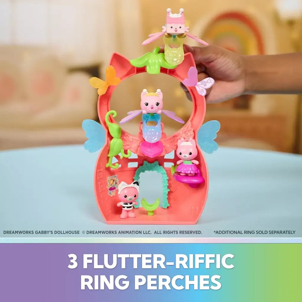 Gabby's Dollhouse ring perches in coral plastic shaped like cat ears with butterfly accents, holding fairy cat figures in tiered positions against a pastel dollhouse backdrop.