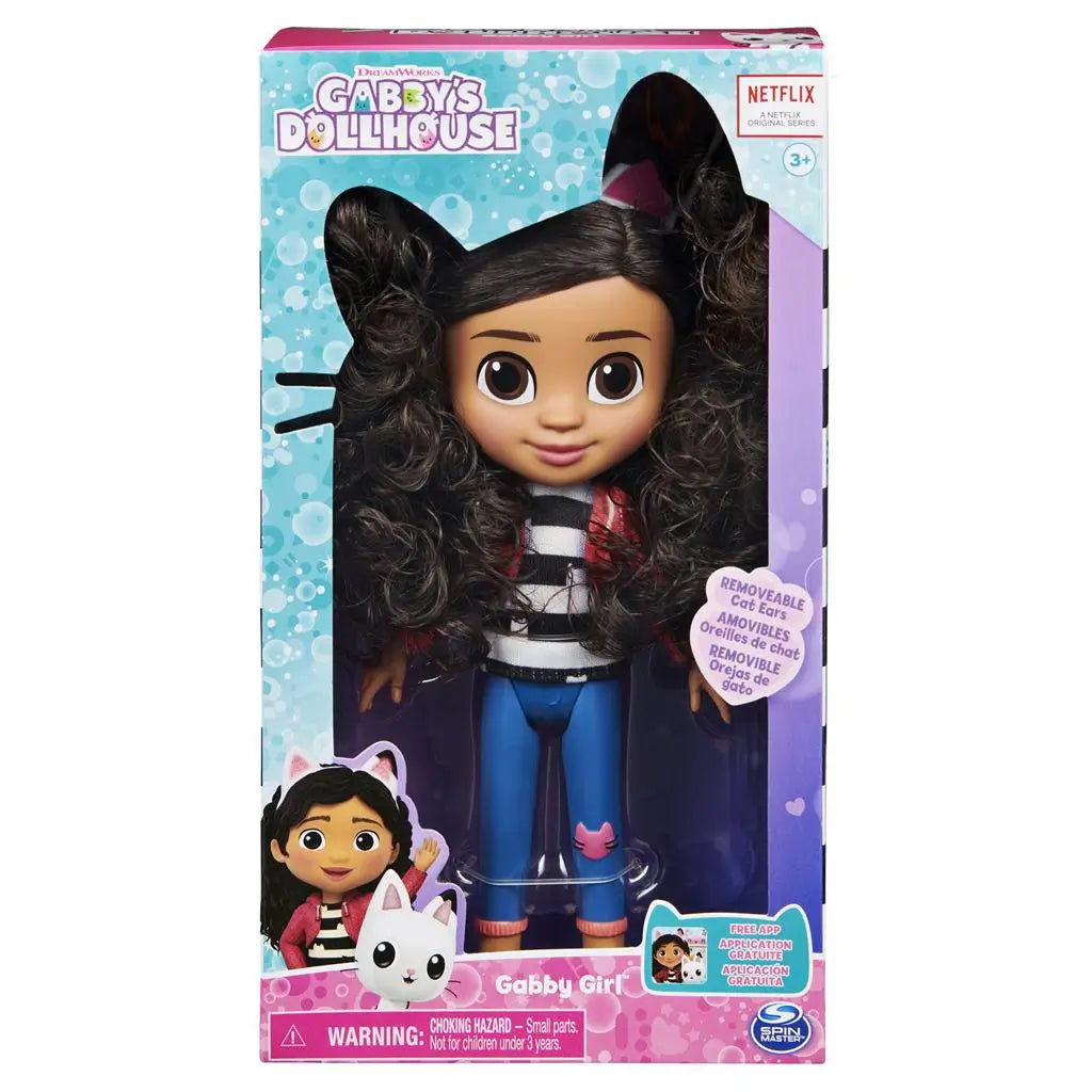Gabby's Dollhouse Gabby Girl doll in teal and purple cardboard packaging with clear plastic display window, featuring curly-haired fashion doll and removable cat ears inside a retail box.