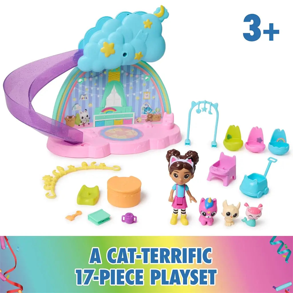 DreamWorks Gabby's Dollhouse Kitty Care Ear Purrfect Playroom 17-piece set in pastel plastic with cloud topper, slide, chairs, kitten figures and small accessories arranged on white.
