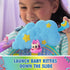 DreamWorks Gabby's Dollhouse Kitty Care Ear Purrfect Playroom blue plastic cloud launcher with yellow stars and crescent moon held by child to send kitten figure down glitter slide.