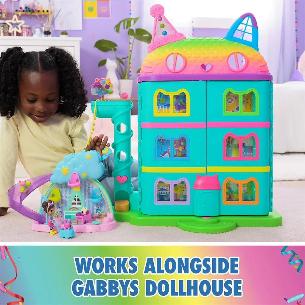 DreamWorks Gabby's Dollhouse Kitty Care Ear Purrfect Playroom in pastel plastic connected to teal cat-shaped dollhouse with rainbow roof, shown in colorful bedroom play setting.