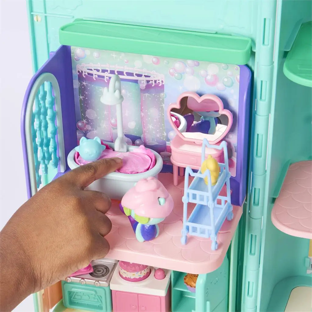 Gabby’s Dollhouse bathtub play feature in pastel blue and pink plastic with rounded basin and shower detail, interactive bubbling effect design, shown inside a dollhouse bathroom setting.