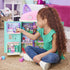 Gabby’s Dollhouse playset in pastel plastic materials with multiroom structure and colorful accessories, designed for imaginative play, shown in a cozy bedroom setting with a child interacting.