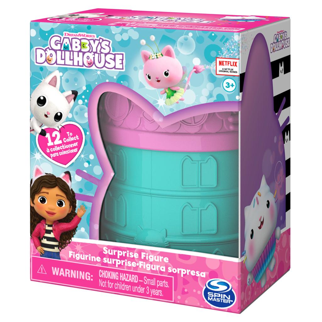Angled view of Gabby’s Dollhouse surprise figure packaging showing 12 collectible mini figures, Gabby character artwork, and Spin Master branding on a bright blue and pink box.