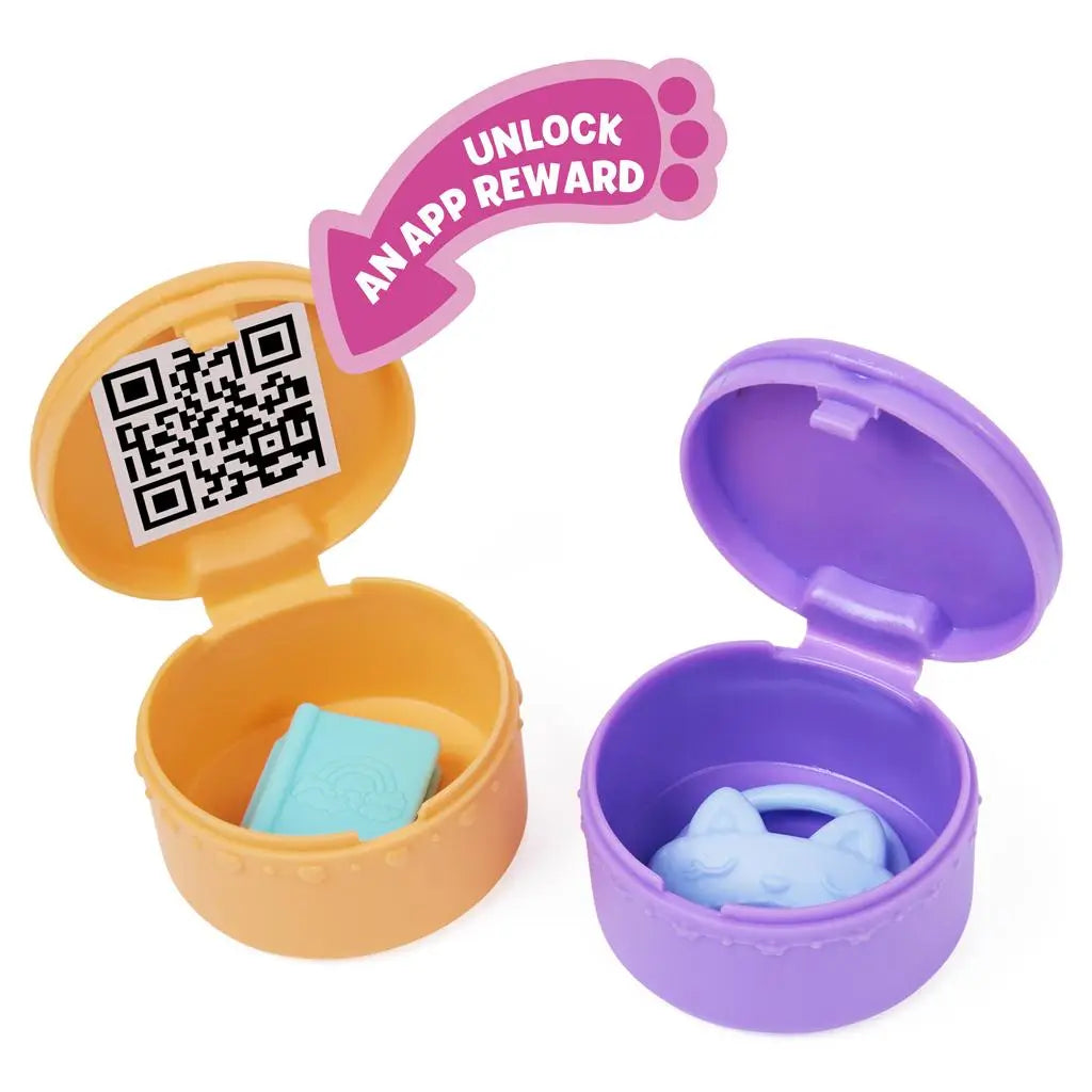 Gabby’s Dollhouse toy surprise capsules in orange and purple plastic with hinged round shapes, smooth texture holding small accessories and QR code reward, displayed open on a clean white background.