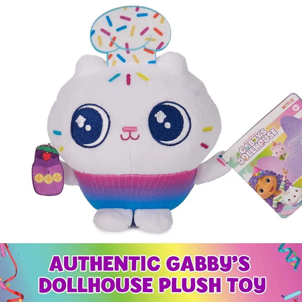 Gabby’s Dollhouse Cakey Cat plush toy white soft fabric cupcake cat with embroidered blue eyes, sprinkle top and rainbow base, authentic branded character shown with product tag on clean background.