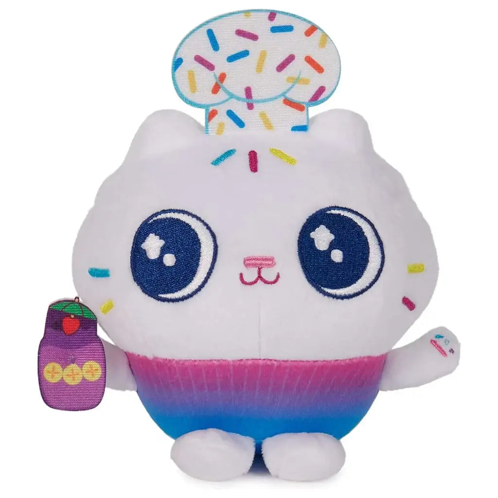 Gabby’s Dollhouse Cakey Cat plush toy in white and pastel pink soft fabric with round cupcake shaped body, embroidered blue eyes, sprinkle details, and gradient base designed as a cute character figure on a clean white background.