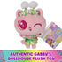 Gabby's Dollhouse Cakey Cat plush toy in pastel pink fabric, rounded kitten form with embroidered face and floral headband, displayed with branded tag on white background indicating authentic product.