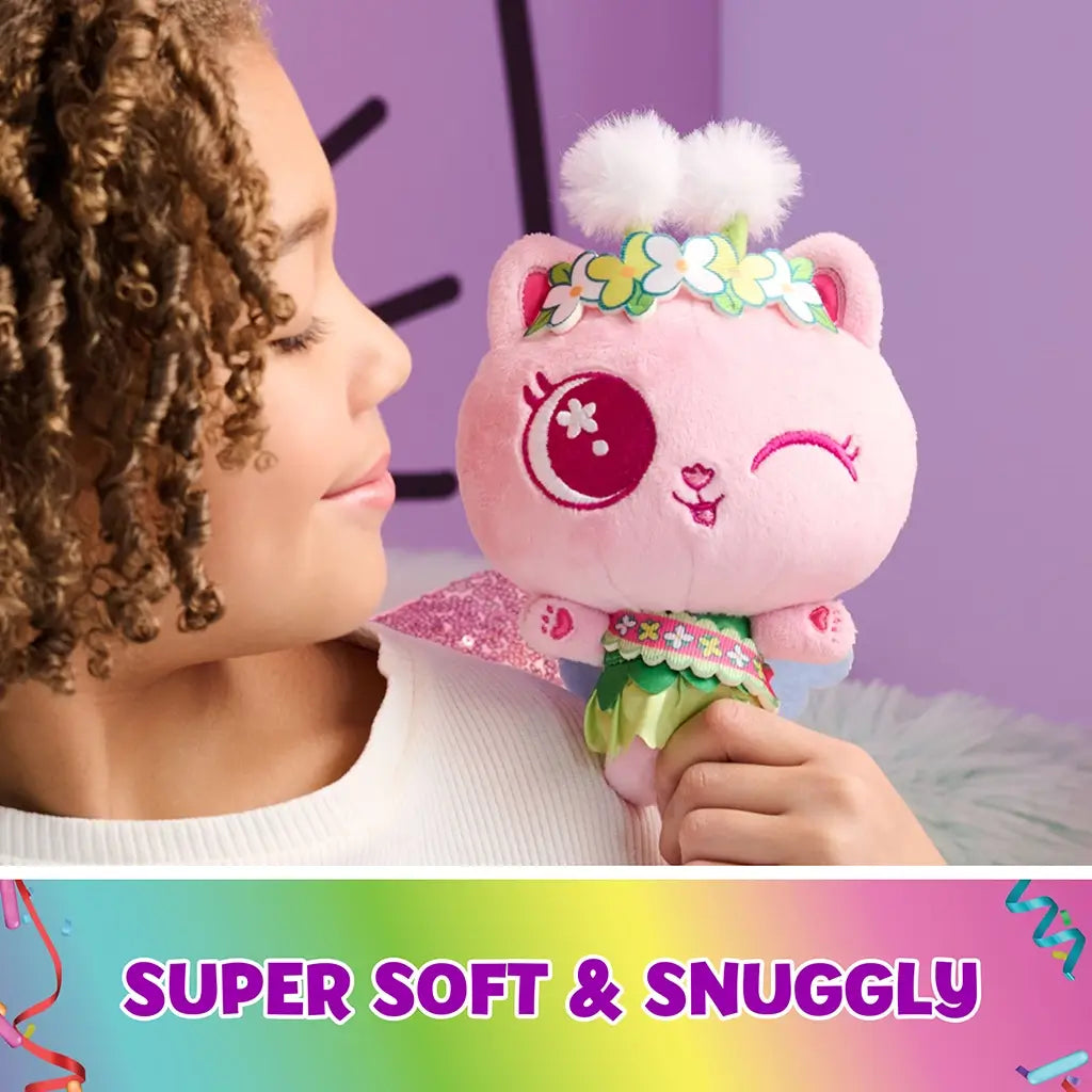 Gabby’s Dollhouse plush toy pink plush cat fairy with soft texture, embroidered wink face, floral crown and layered green skirt, designed as a snuggly cuddle companion in pastel room.