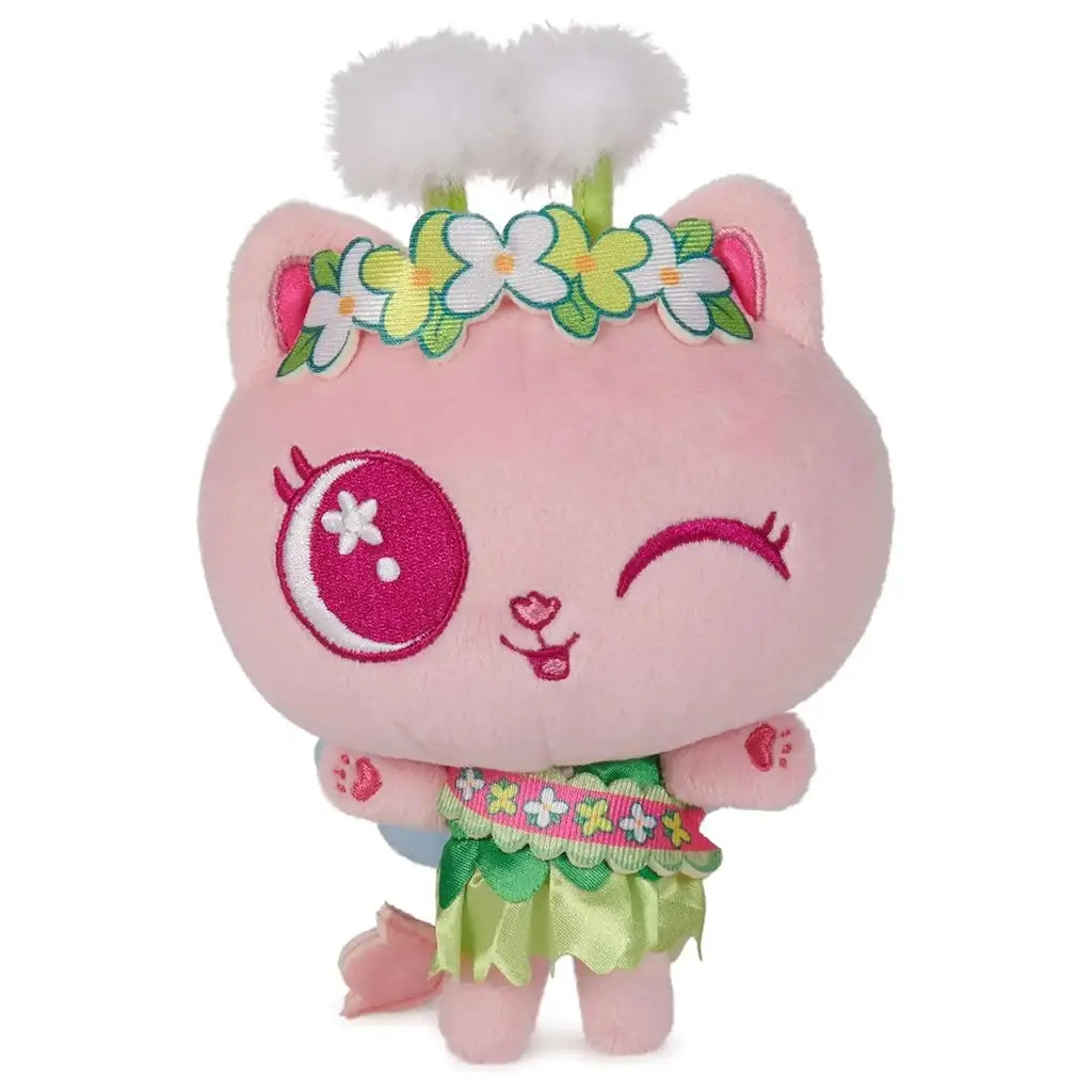 Gabby’s Dollhouse Cakey Cat fairy plush toy in soft pink fabric with round head, embroidered winking eye, floral crown with fluffy accents, and green skirt outfit designed as a cute character figure on a clean white background.