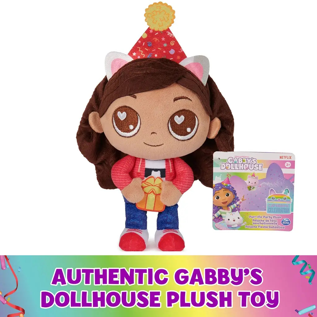 Gabby's Dollhouse plush toy in vibrant red, blue, and brown fabric, rounded doll shape with embroidered eyes and party hat, displayed with branded tag on white background, indicating authentic licensed product.