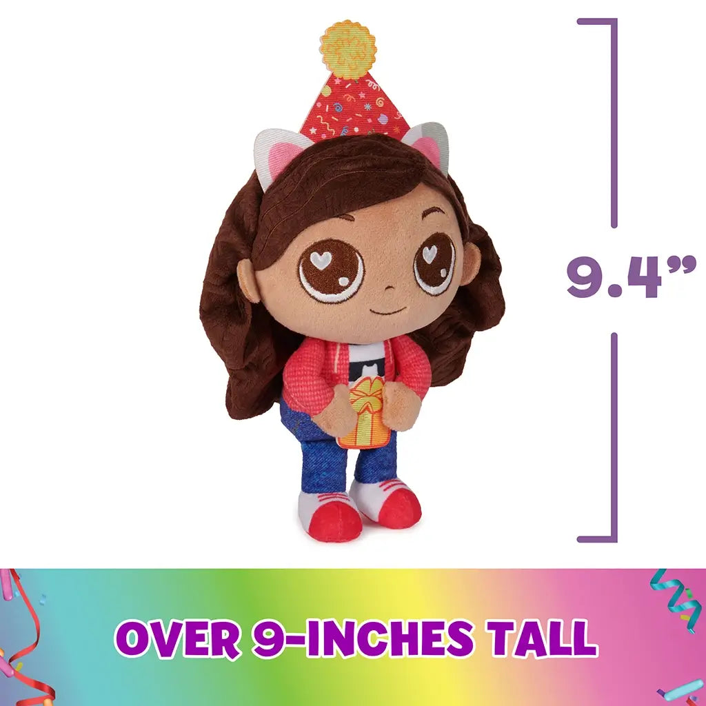 Gabby's Dollhouse plush toy in red, blue, and brown soft fabric, upright doll shape with stitched features and party hat, shown against white background with size marker, highlighting over nine inches tall.