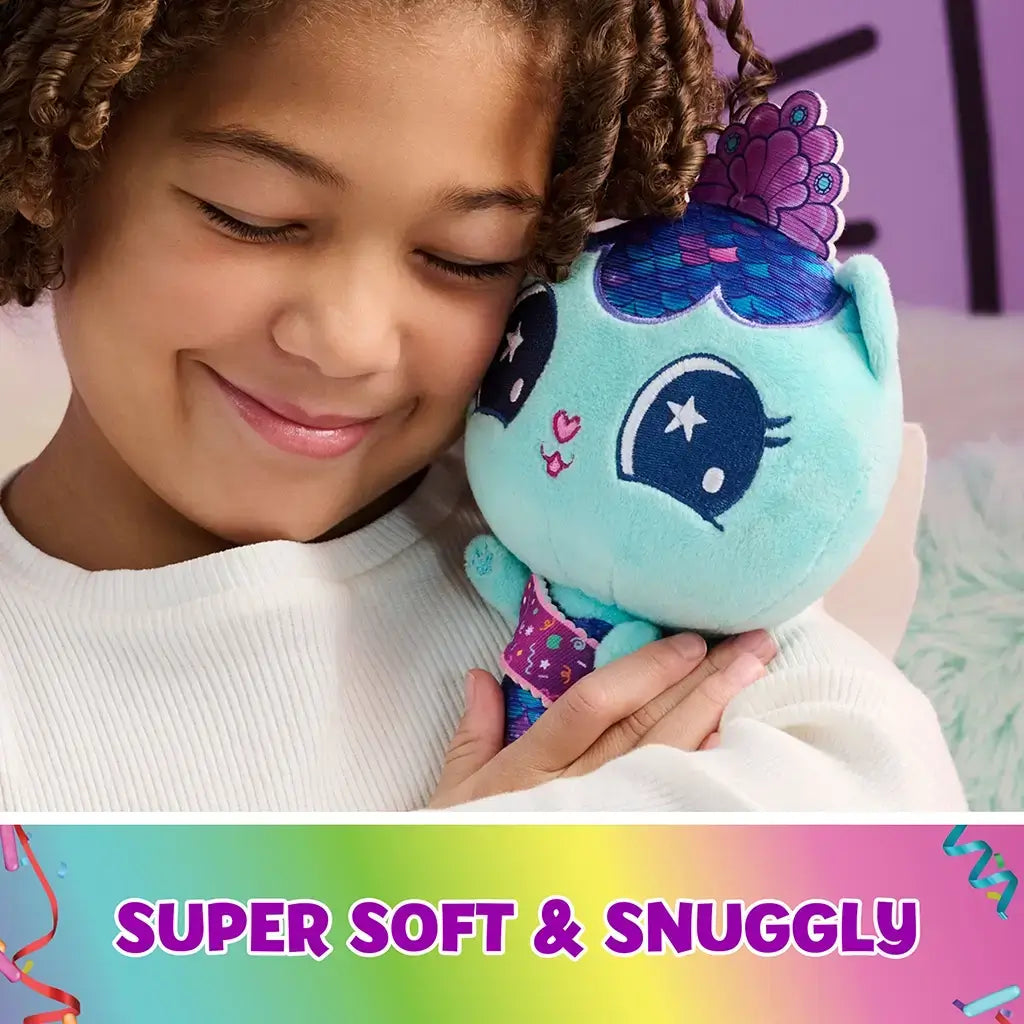 teal plush mermaid cat toy Gabby's Dollhouse, soft plush fabric with purple blue tail and embroidered face, rounded huggable shape held by a smiling child in a cozy indoor setting