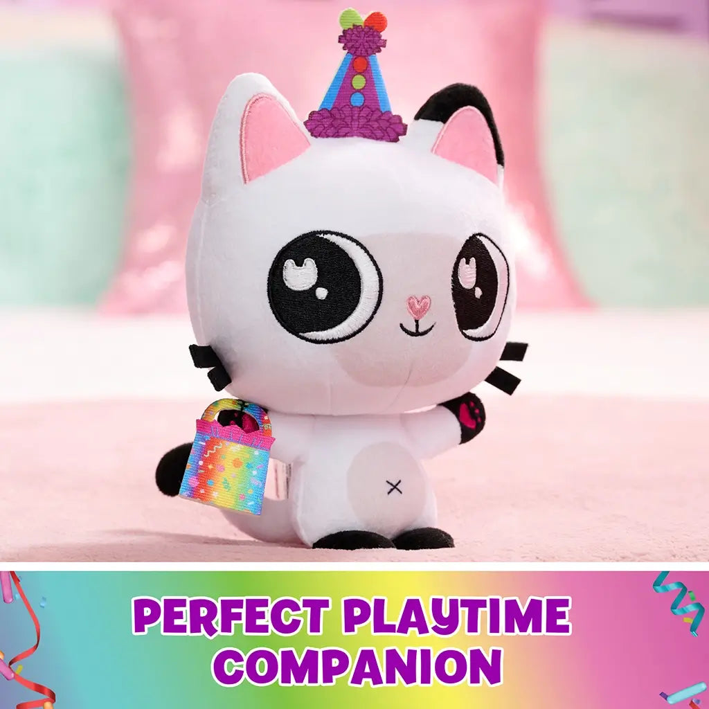 Gabby’s Dollhouse Pandy Paws plush toy white plush cat with smooth texture, black ears and colorful party hat, holding rainbow accessory, designed as playful companion on pastel surface setting.