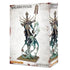 Nagash Warhammer miniature, pale bone-textured undead figure with ornate gold armor and elongated skeletal form, holding a tall staff as translucent green spirit shapes coil upward from the base in a dark fantasy setting.