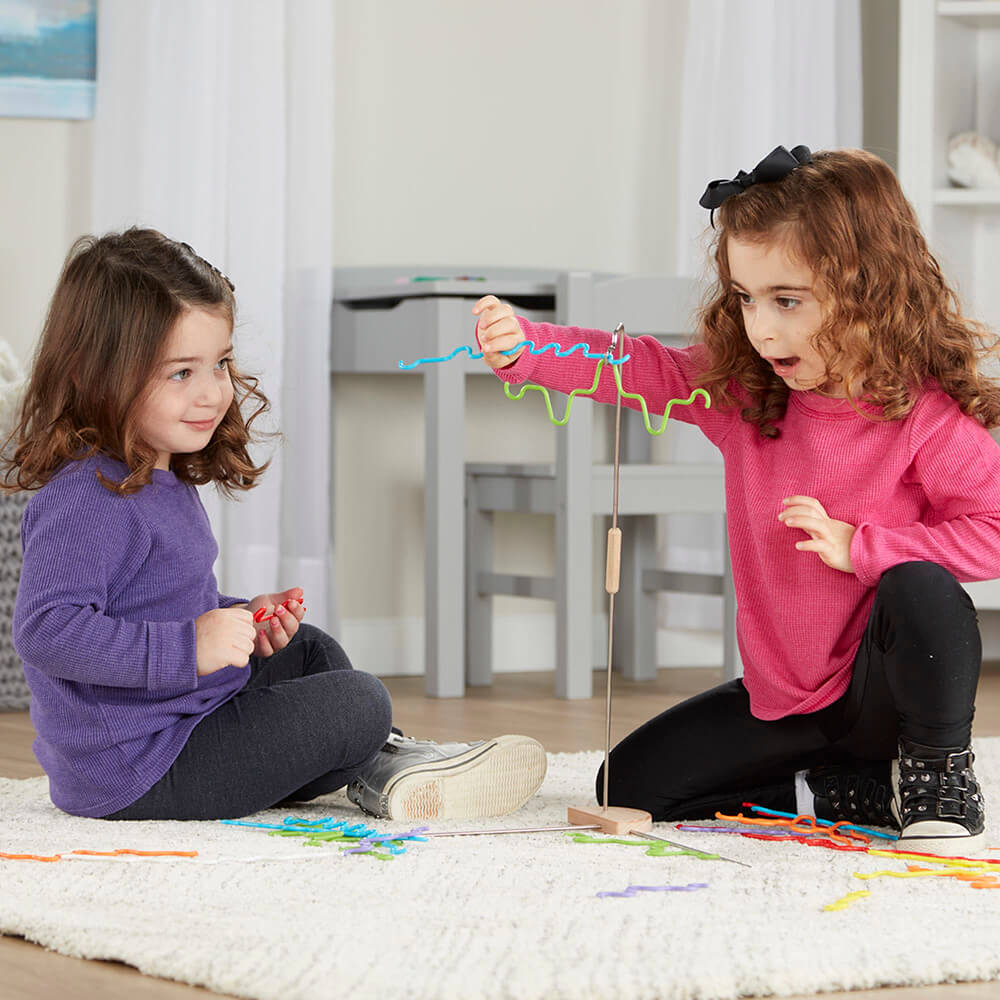 Two girls face the challenge of winning the Melissa and Doug Suspend Junior Balance Game