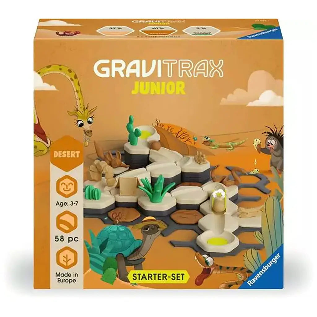 Front packaging of GraviTrax Junior Desert Starter Set for ages three to seven, showing desert-themed track, cactus, and animal figures with bold orange background design.