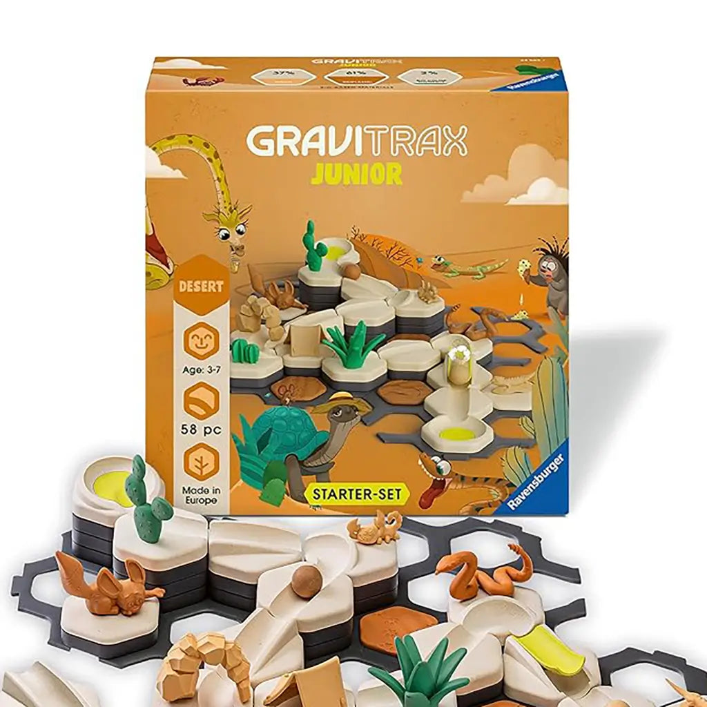 GraviTrax Junior Desert Starter Set product box with desert colors and animal illustrations, displayed with hexagonal track tiles, ramps, and cactus figures arranged below.