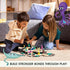 Two children sitting on a rug playing with GraviTrax Junior Ocean Starter Set, moving marine animal figures on hexagonal tiles, with cartoon octopus and stingray beside.