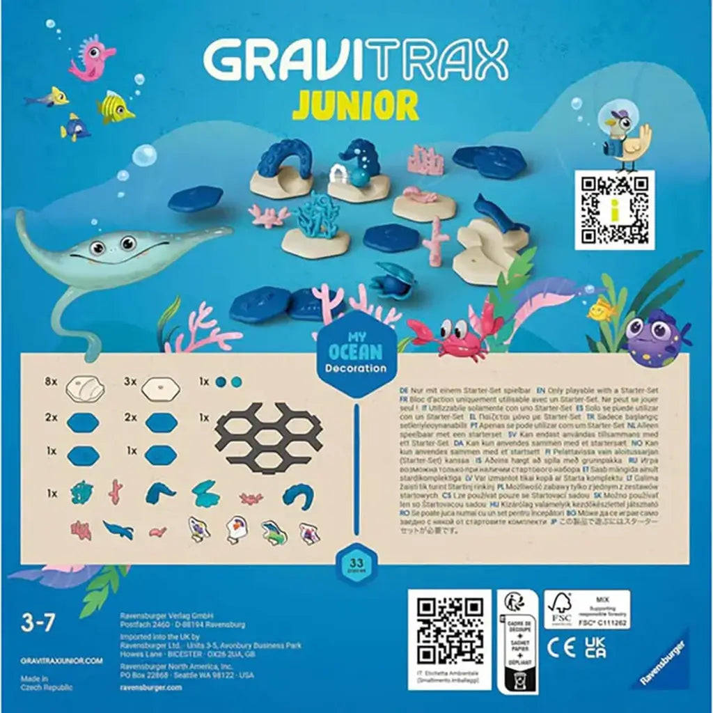 Back of GraviTrax Junior Ocean Starter Set package showing included coral, sea animals, track tiles, and accessories, with ocean illustrations and QR code for details.